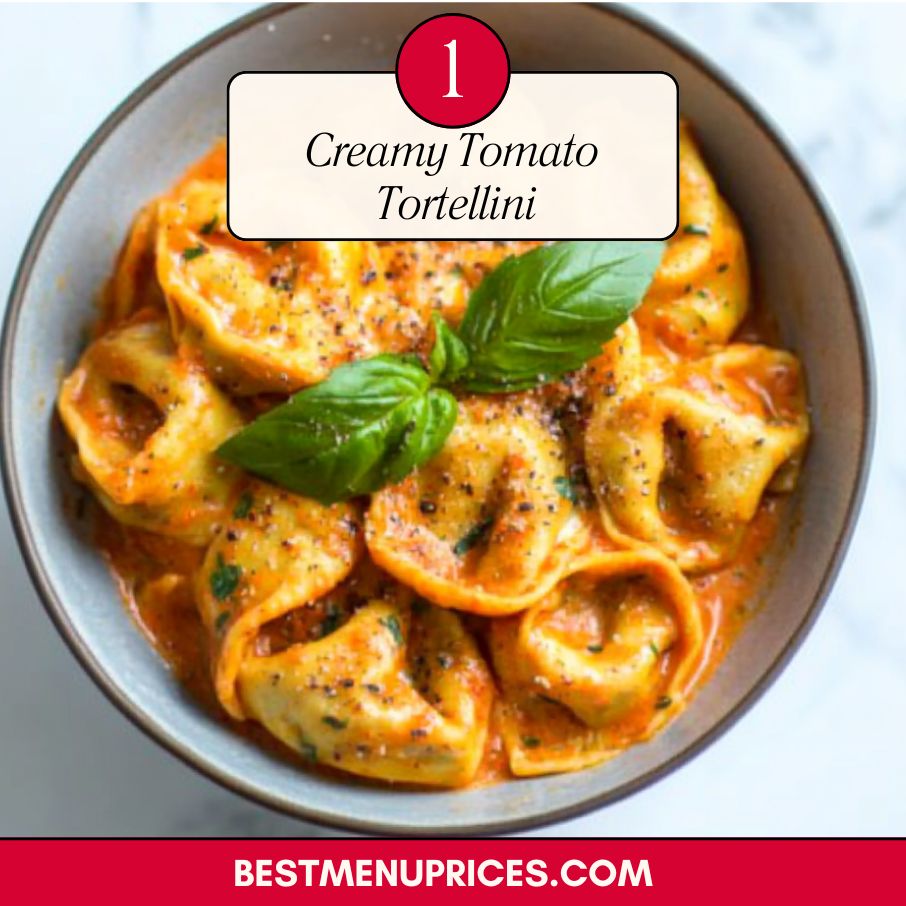 A bowl of creamy tomato tortellini pasta served with fresh basil and Parmesan cheese, perfect for an easy and comforting dinner
